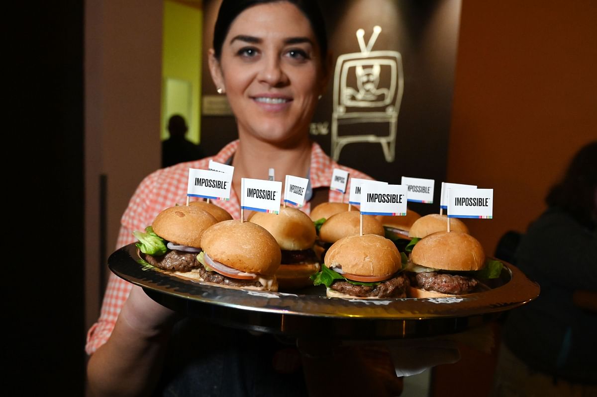 In this AFP file photo taken on 7 January 2019, The Impossible Burger 2.0, the new and improved version of the company's plant-based vegan burger that tastes like real beef is introduced at a press event during CES 2019 in Las Vegas, Nevada.
