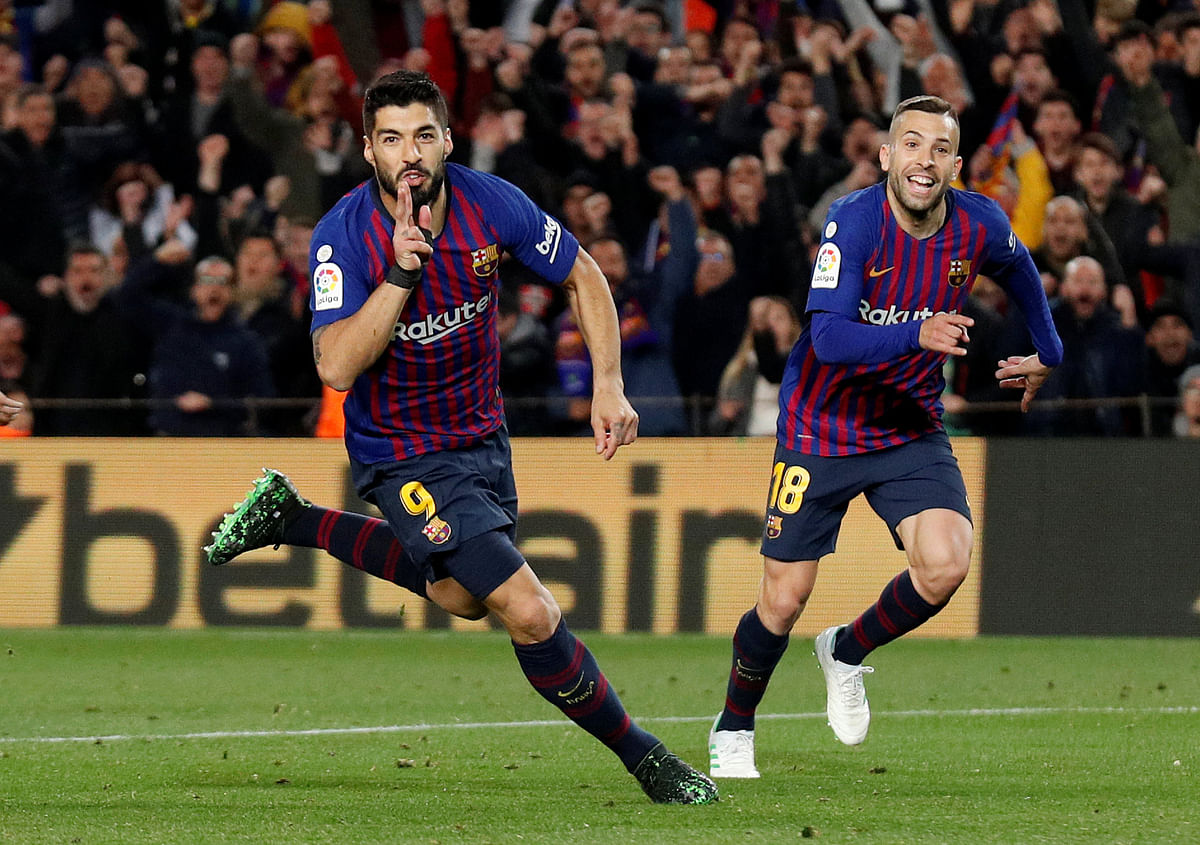 Barcelona`s Luis Suarez celebrates scoring their first goal with Jordi Alba in a La Liga match against Atletico Madrid at Camp Nou, Barcelona, Spain on 6 April 2019. Photo: Reuters