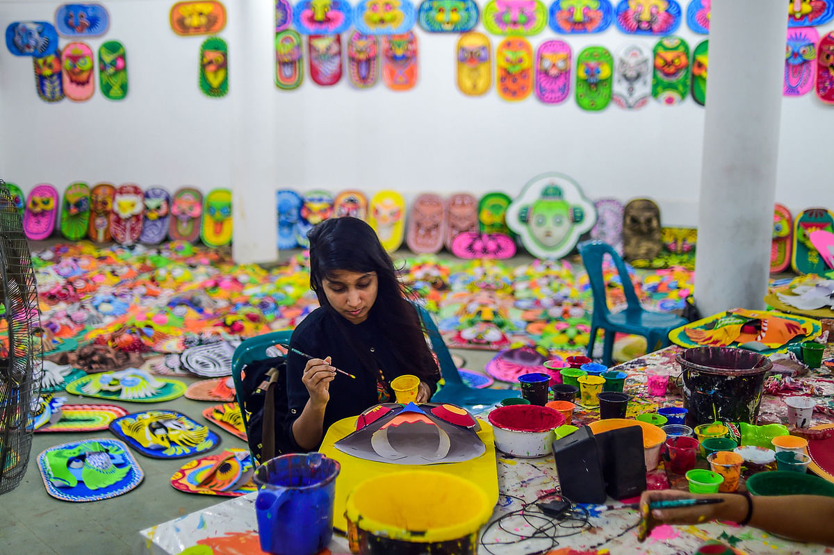 A student of Dhaka University Art Institute paints a mask to sell as a part of Bengali New Year preparations in Dhaka on 7 April 2019. Photo: AFP