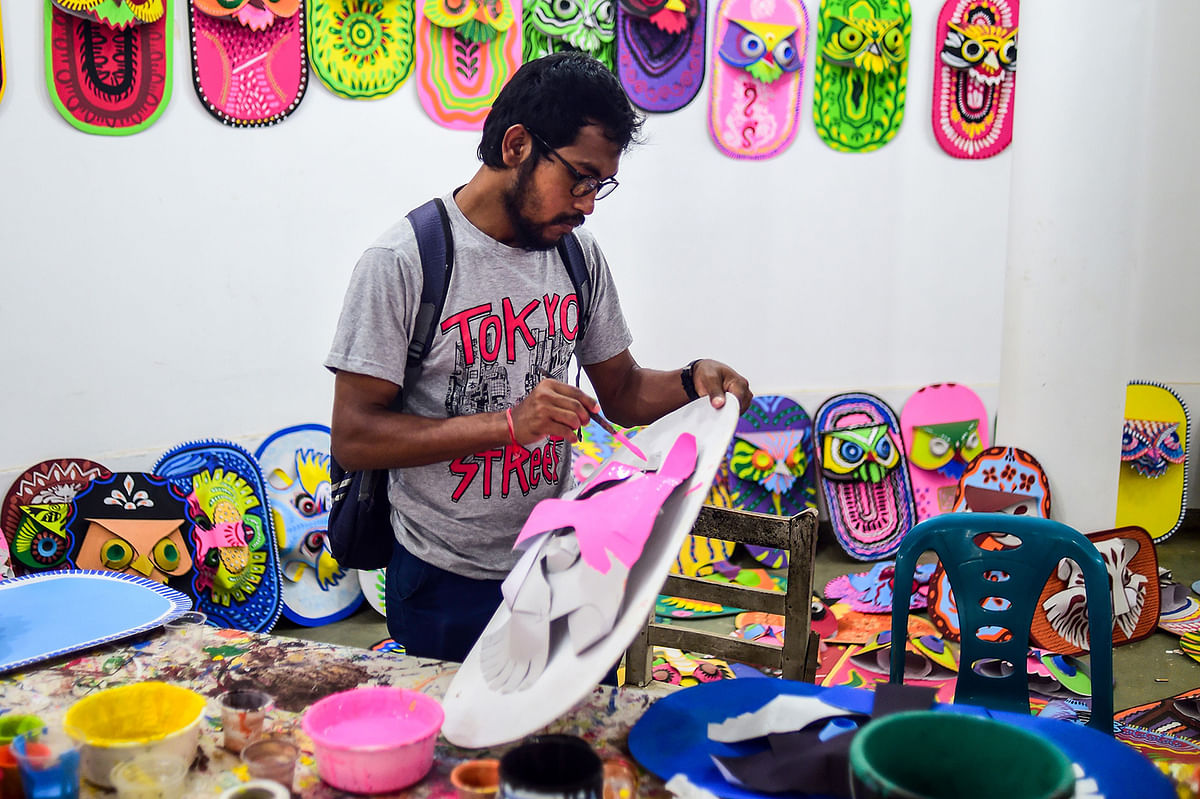 A student of Dhaka University Art Institute paints a mask to sell as a part of Bengali New Year preparations in Dhaka on 7 April 2019. Photo: AFP