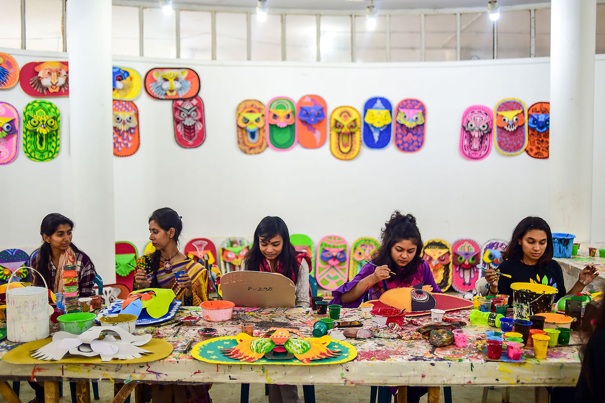 Students of Dhaka University Art Institute paint masks to sell as a part of Bengali New Year preparations in Dhaka on 7 April 2019. Photo: AFP