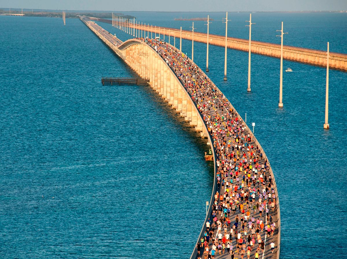 In this image courtesy of the Florida Keys News Bureau, a portion of the field of 1,500 participants begins the trek to the highest point over the Florida Keys Overseas Highway`s longest span during the Seven Mile Bridge Run Saturday, 6 April 2019, near Marathon, Florida. Photo: AFP