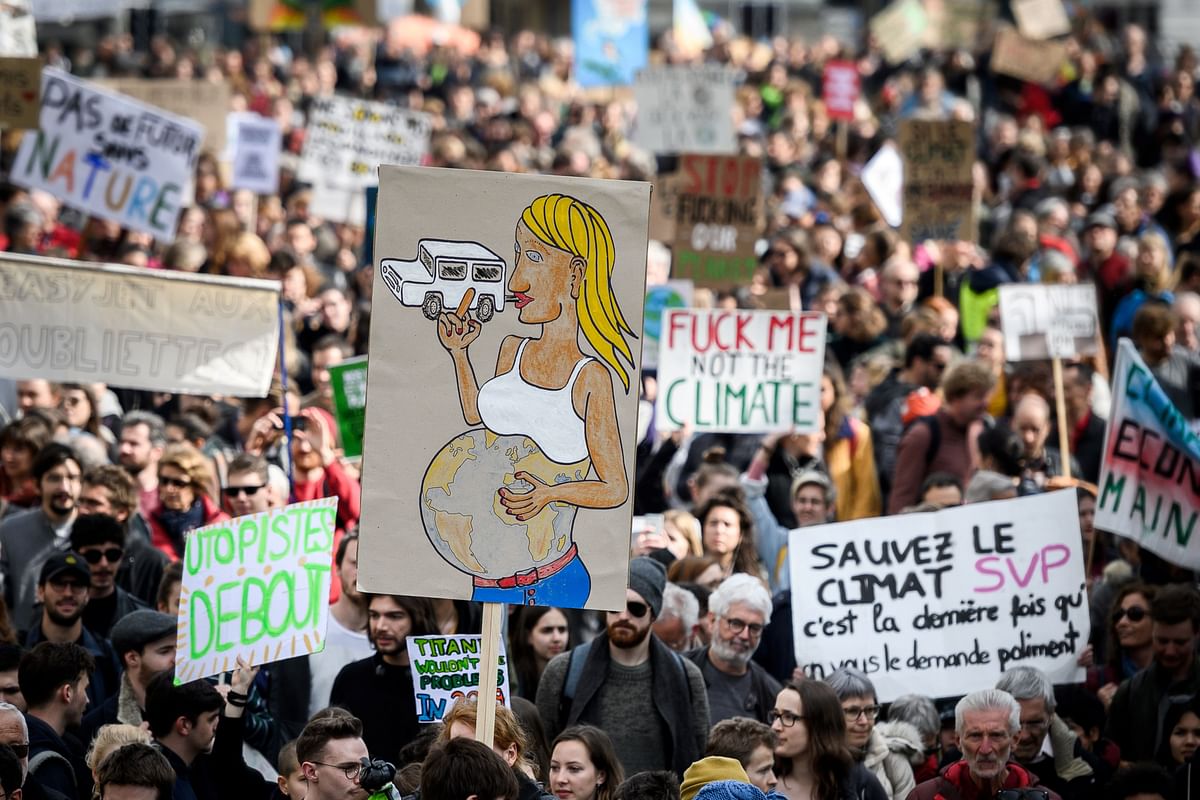 Demonstrators hold placards during a protest against climate change on 6 April 2019 in Lausanne. Thousands took part in several cities across Switzerland to protest against climate change, inspired by Swedish youth activist Greta Thunberg. Photo: AFP