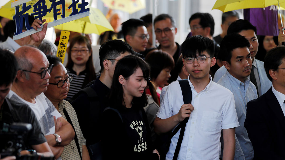 Former student leader Joshua Wong and activist Agnes Chow arrive at the court to support leaders of Occupy Central activists, in Hong Kong, China on 9 April 2019. Photo: Reuters