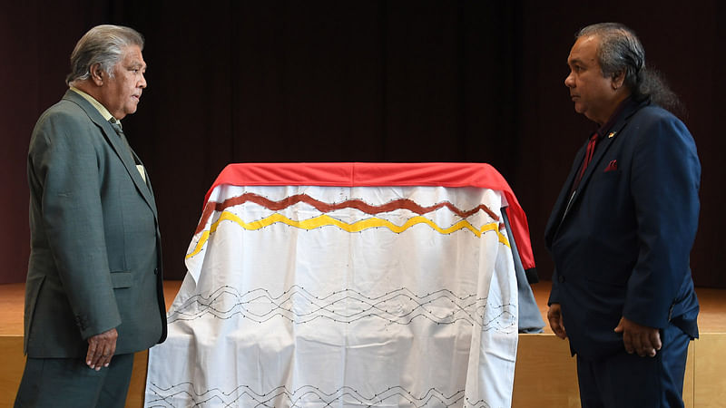 Neville Reys (R) and Gerald Fourmile prepare the coffin with the remains of an Australian aboriginal in the museum of the five continents in Munich, southern Germany, on 9 April 2019 during a handing over ceremony. Photo: AFP