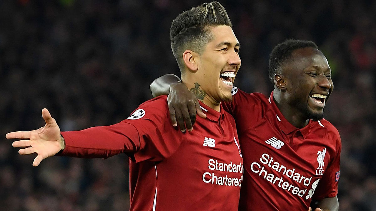 Liverpool`s Guinean midfielder Naby Keita (R) celebrates with Liverpool`s Brazilian midfielder Roberto Firmino after scoring a goal during the UEFA Champions League quarter-final, first leg football match between Liverpool and FC Porto at Anfield stadium in Liverpool, north-west England on April 9, 2019. AFP