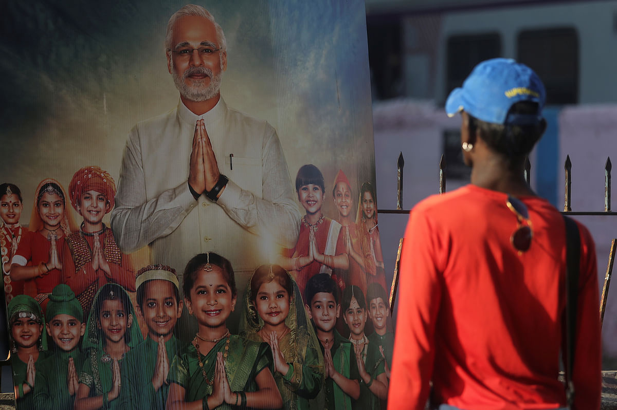 A man looks at the poster of upcoming film `PM Narendra Modi` outside a theater in Mumbai. Photo: Reuters