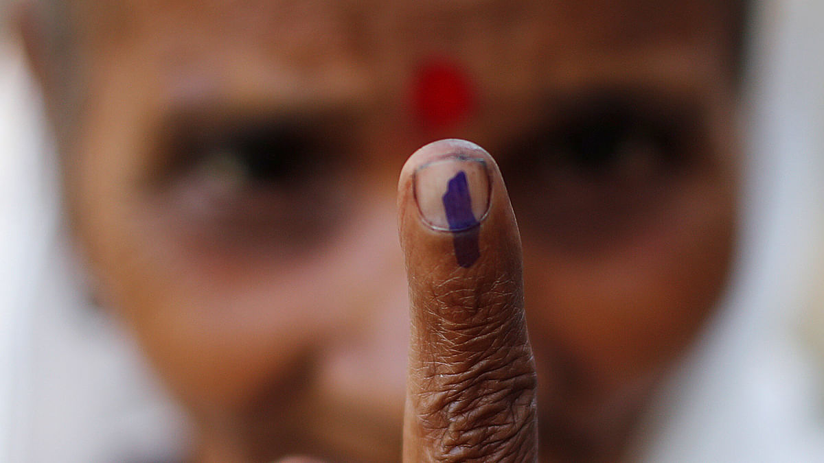 A woman shows her ink-marked finger after casting her vote at a polling station in Majuli, a large river island in the Brahmaputra river, in the northeastern Indian state of Assam, India on 11 April 2019. Photo: Reuters