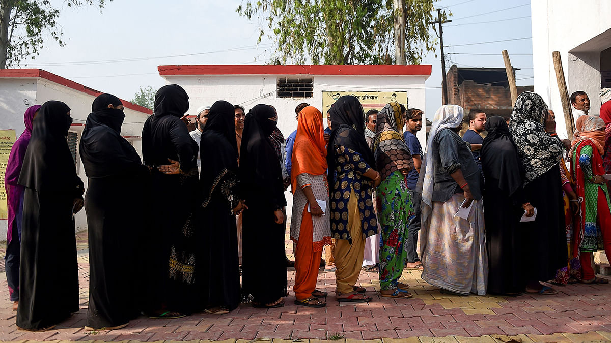 Indian voters stand in a queue to cast their vote at a polling station during India`s general election in in Kawaal village near Muzaffarrnagar in the northern Indian state of Uttar Pradesh on 11 April 2019. Photo: AFP