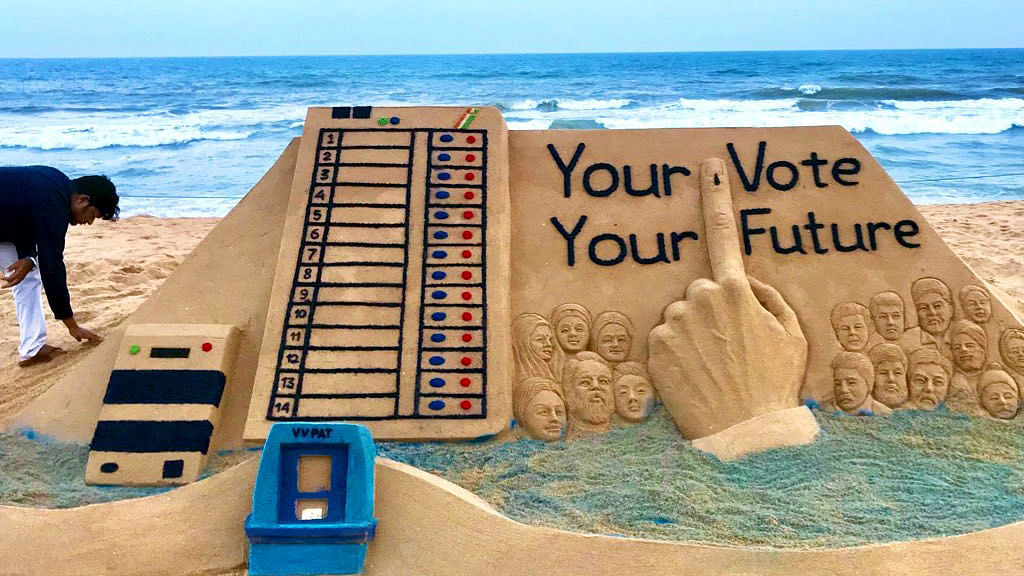 Sudarsan Pattnaik with sand art `Your Vote Your Future`. Photo: IANS