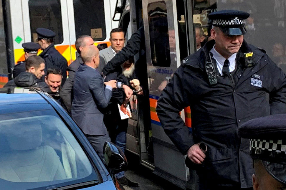 WikiLeaks founder Julian Assange is handled by Metropolitan Police officers during his arrest and taken into custody following the Ecuadorian government`s termination of asylum, in London, Britain on 11 April 2019. Photo: Reuters