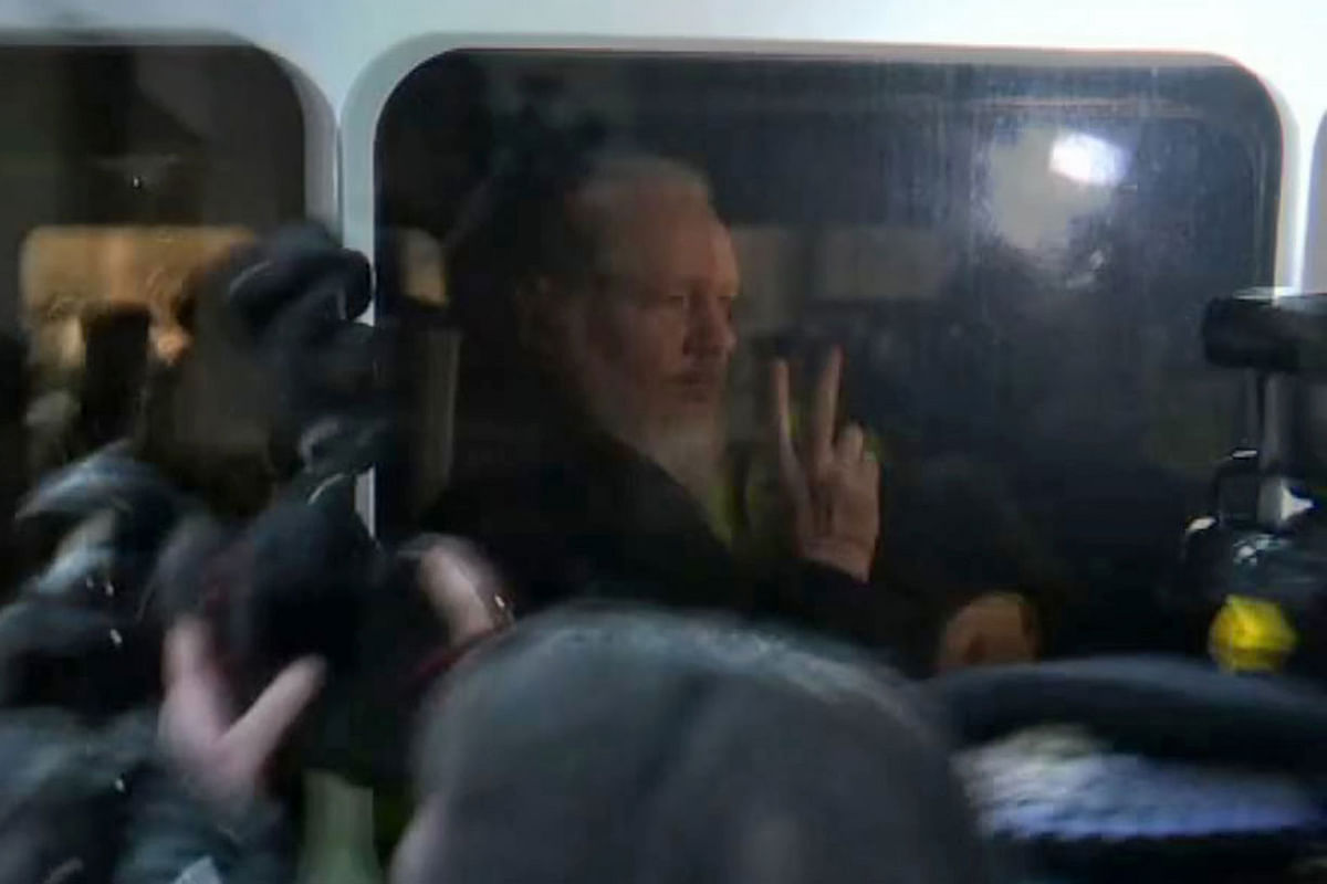 A video grab taken from AFP TV footage shows WikiLeaks founder Julian Assange as he is driven by British Police to Westminster Magistrates Court in London on 11 April 2019. Photo: AFP