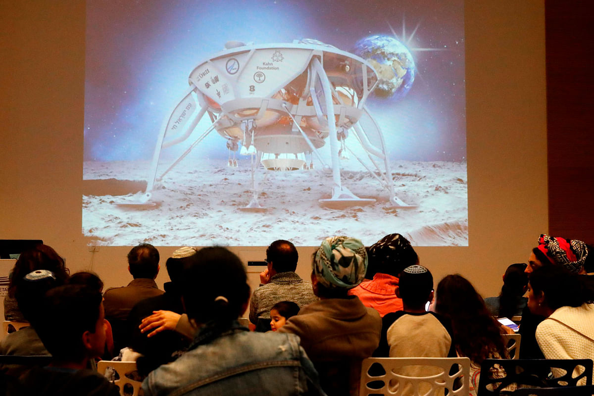 People watch a screen showing explanations of the landing of Israeli spacecraft, Beresheet`s, at the Planetaya Planetarium in the Israeli city of Netanya, on 11 April 2019 before it crashed during the landing. Photo: AFP