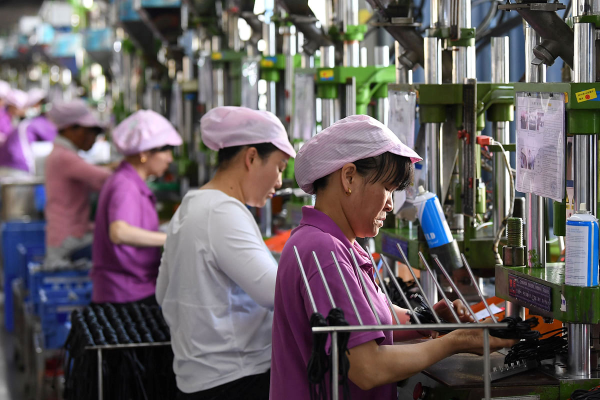 Women work on a data cable production line at a factory in Xinyu, Jiangxi province, China on 8 April 2019. Photo: Reuters