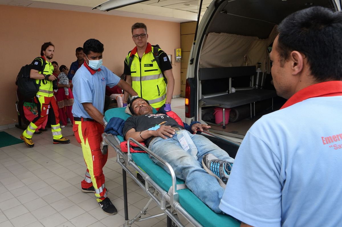 Medical staff take plane crash victim Syangboche Karki to Grande International Hospital, in Kathmandu on 14 April. Photo: AFP