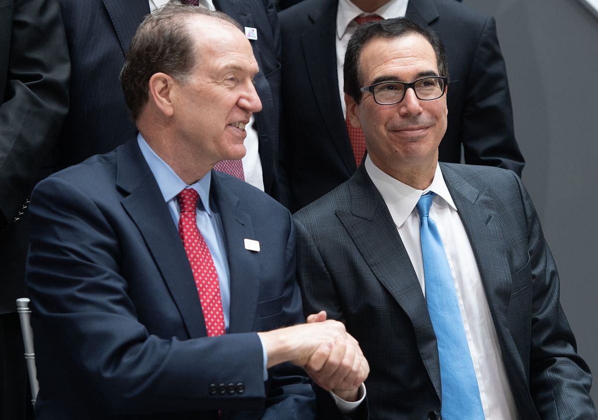 World Bank president David Malpass (L) shakes hands with US Treasury Secretary Steven Mnuchin prior to the G20 finance ministers and Central Bank Governors Meeting family photo during the IMF World Bank Spring Meetings at International Monetary Fund Headquarters in Washington, DC on 12 April. Photo: AFP