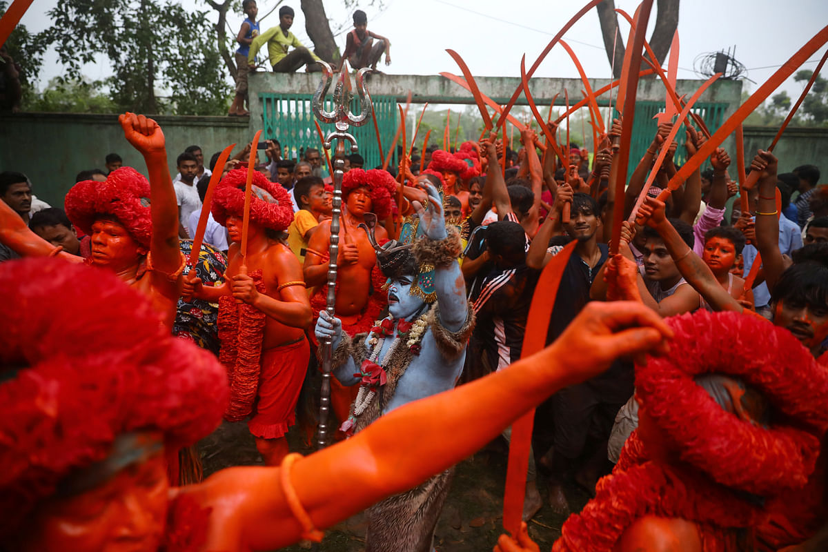 Hindu devotees join in a rally after applying colour on their body as they celebrate Lal Kach festival in Munshiganj, Bangladesh on 13 April 2019. Photo: Reuters