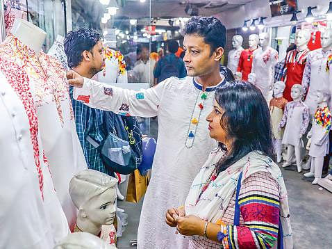 Shopping complexes and roadside shops are teeming with customers on the occasion of Pahela Baishakh, the first day of Bangla New Year, a traditonal festival of Bangalees. Customers are choosing clothes at a shop of Aziz Co-Operative Super Market in Shabagh. Photo: Sabina Yeasmin