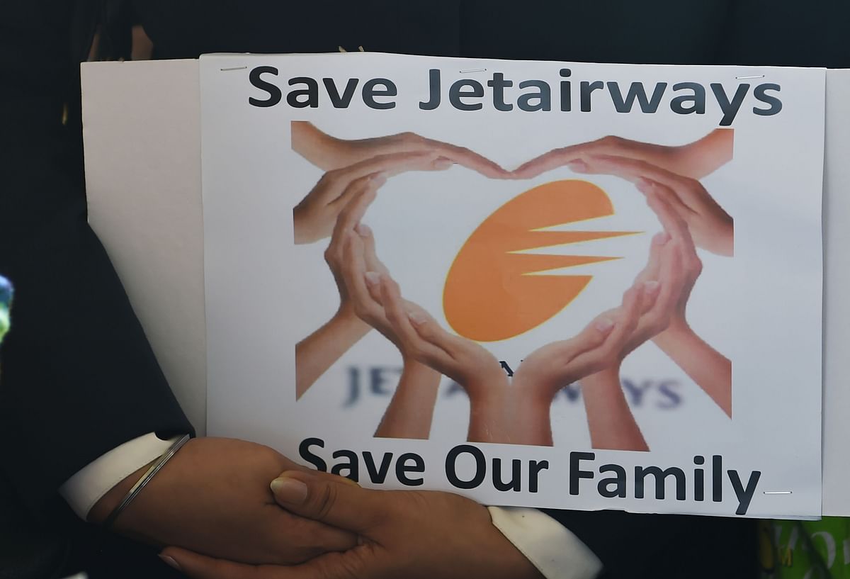 A Jet Airways employee holds a placard during a protest at the Chattrapati Shivaji International airport in Mumbai on 12 April 2019. Photo: AFP