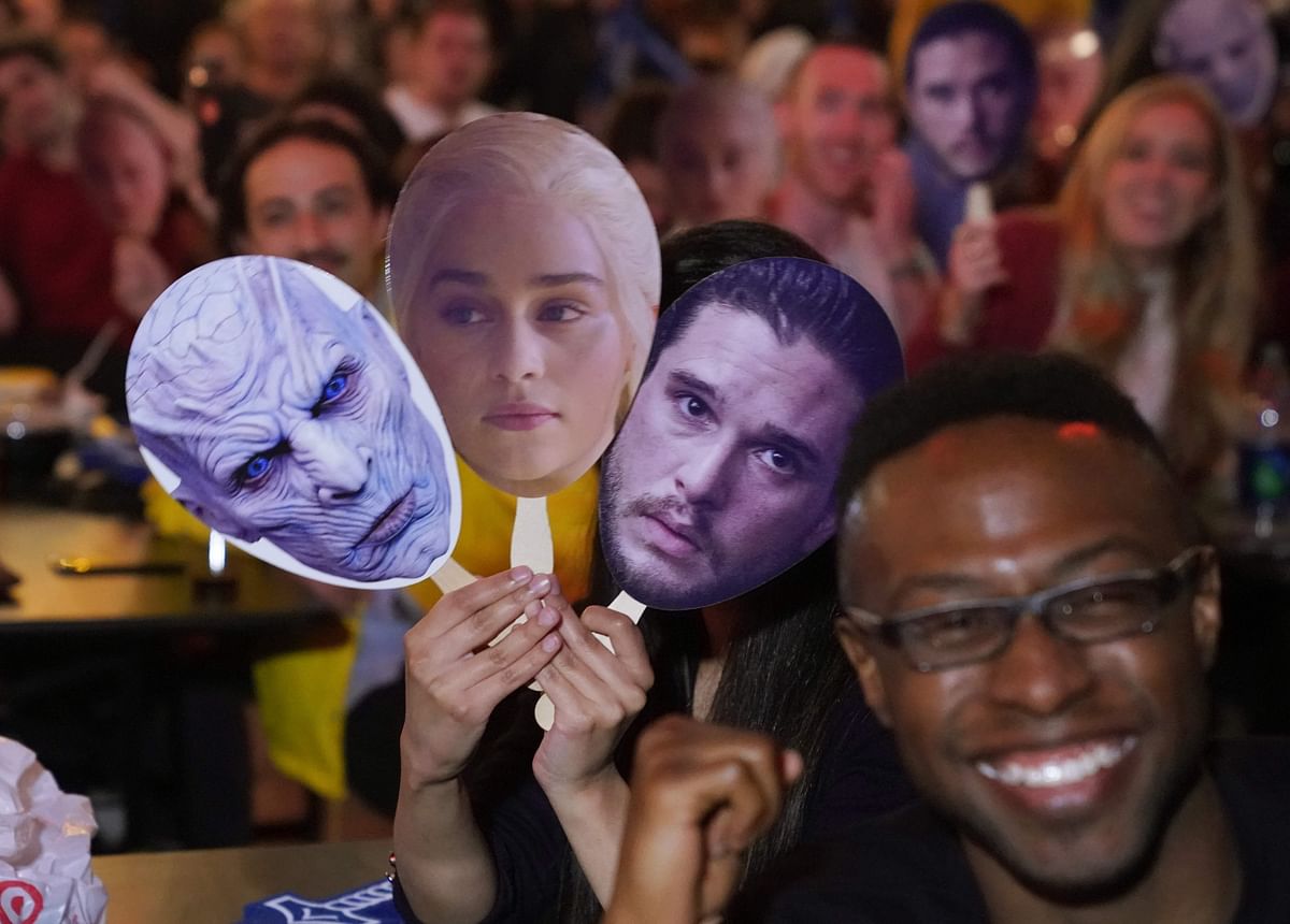 Game of Thrones fans hold up masks as they wait for the start of the `Game of Thrones` premiere party at the Understudy bar in Brooklyn in New York on 14 April 2019. Photo: AFP