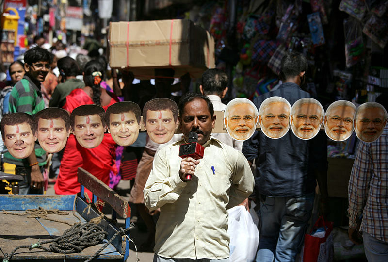Anand Kumar Bowmick, a social activist, carries masks of prime minister Narendra Modi and president of India`s main opposition Congress party Rahul Gandhi through a busy street as he appeals people to vote in the second phase of general election, in Chennai, India, on 16 April 2019. Photo: Reuters