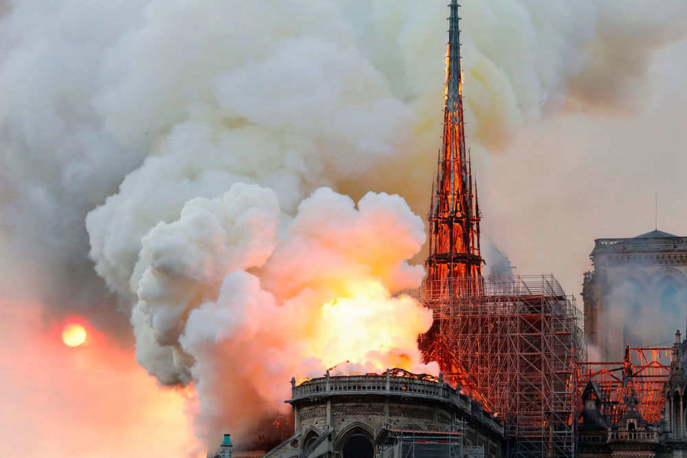 Smoke and flames rise during a fire at the landmark Notre-Dame Cathedral in central Paris on 15 April 2019, potentially involving renovation works being carried out at the site, the fire service said. Photo: AFP