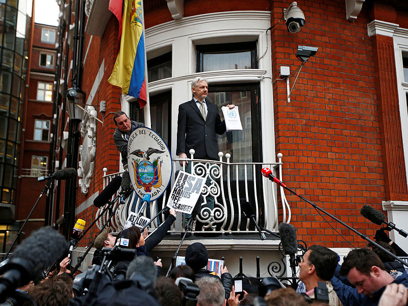 WikiLeaks founder Julian Assange holds a copy of a UN ruling as he makes a speech from the balcony of the Ecuadorian Embassy, in central London, Britain on 5 February 2016. Reuters File Photo