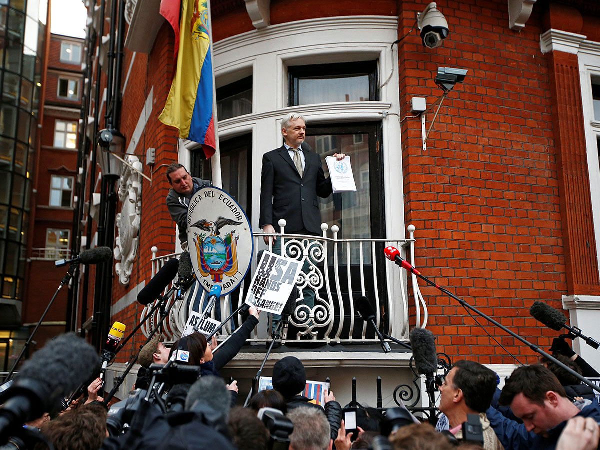 WikiLeaks founder Julian Assange holds a copy of a UN ruling as he makes a speech from the balcony of the Ecuadorian Embassy, in central London, Britain on 5 February 2016. Reuters File Photo
