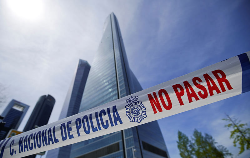 A police tape reading: `Do not pass` is pictured in front of the towers of a skyscraper housing embassies, after a bomb threat, in Madrid, Spain, on 16 April 2019. Photo: Reuters