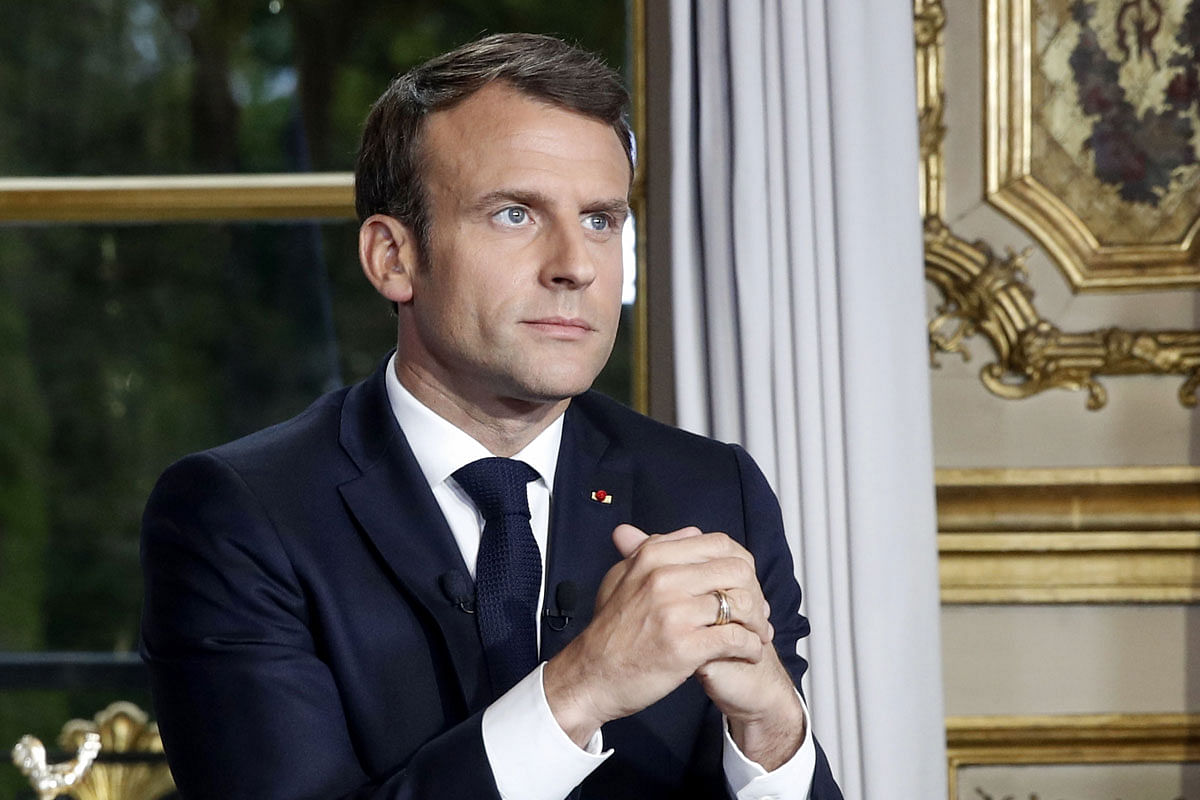 French president Emmanuel Macron sits at his desk after addressing the nation on 16 April during which he vows to rebuild Notre-Dame de Paris Cathedral within five years, a day after a fire erupted in the 850-year-old landmark, and Macron had cancelled a speech expected to outline key measures in response to months of anti-governments protests.
