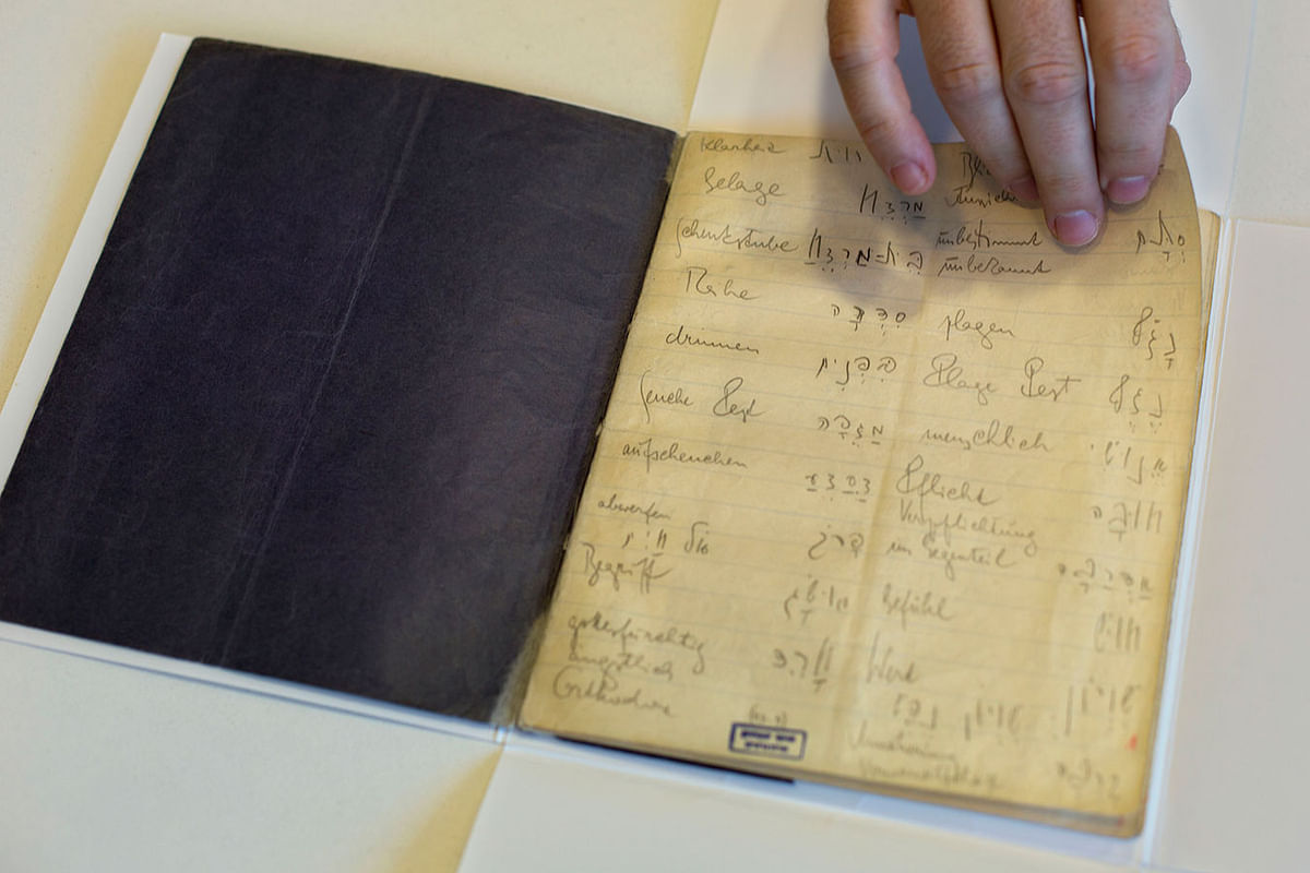 In this file photo taken on 5 October 2014, a library official shows celebrated author Franz Kafka`s Hebrew vocabulary notebook at Israel`s National Library in Jerusalem. A long-hidden trove of unpublished works by Franz Kafka could soon be revealed following a decade-long battle over his literary estate that has drawn comparisons to some of his surreal tales. Photo: AP