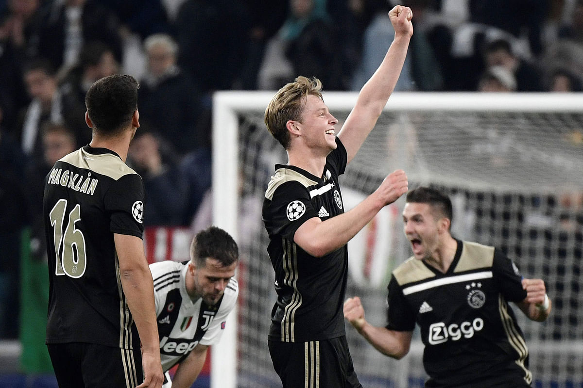 Ajax players celebrate their UEFA Champions League quarter-final second leg win over Juventus in Turin. AFP