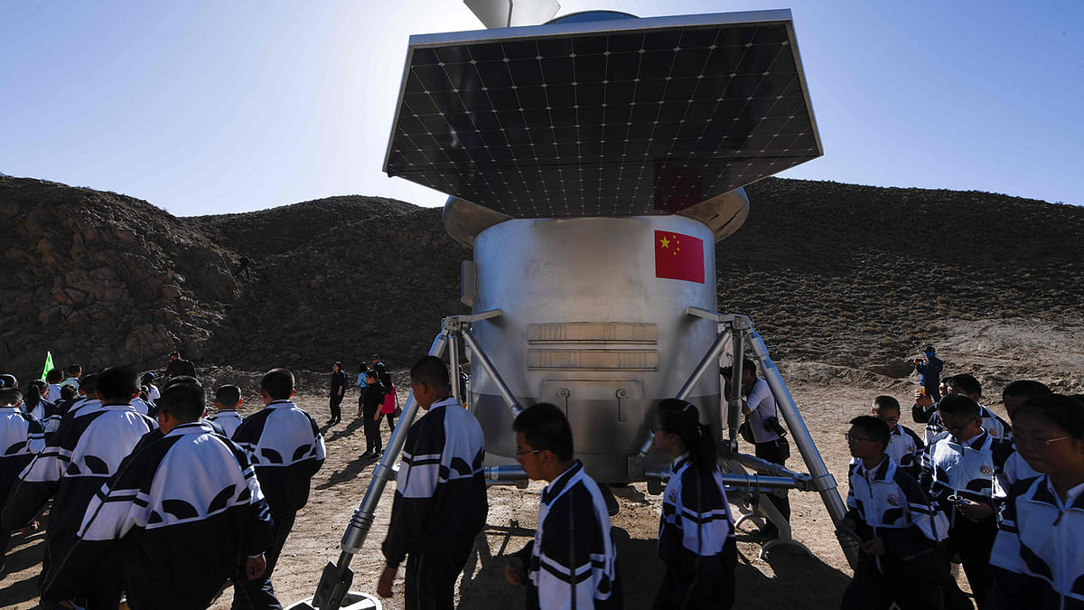 group of students walk past a model of a lander at `Mars Base 1`, a C-Space Project, in the Gobi desert, some 40 kilometres from Jinchang in China`s northwest Gansu province on 17 April 2019. Surrounded by barren hills in northwest Gansu province, `Mars Base 1` opened to the public on April 17 with the aim of exposing teens -- and soon tourists -- to what life could be like on the planet. Photo: AFP