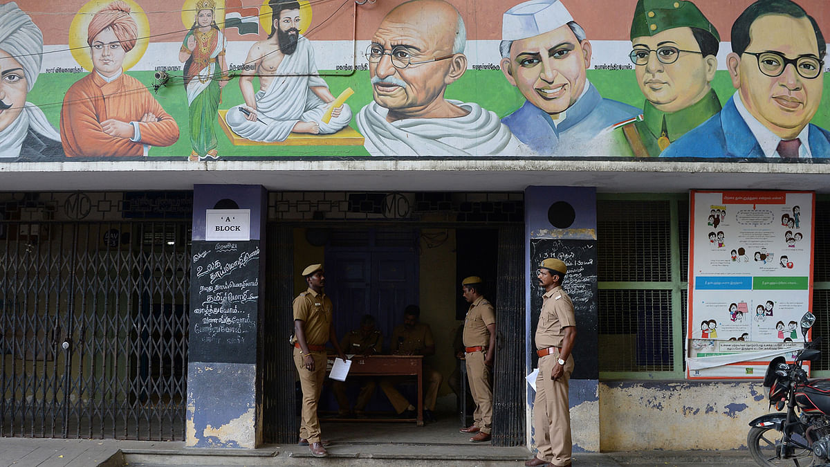 Indian police gestures as they stand guard in front of a polling station in Chennai on 17 April 2019, ahead of the second phase of India`s general election, in the southern Indian state of Tamil Nadu. Photo: AFP