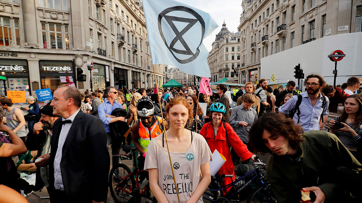 Climate change activists block the road junction at Oxford Circus in central London on 18 April 2019, during the fourth day of an environmental protest by the Extinction Rebellion group. Photo: AFP