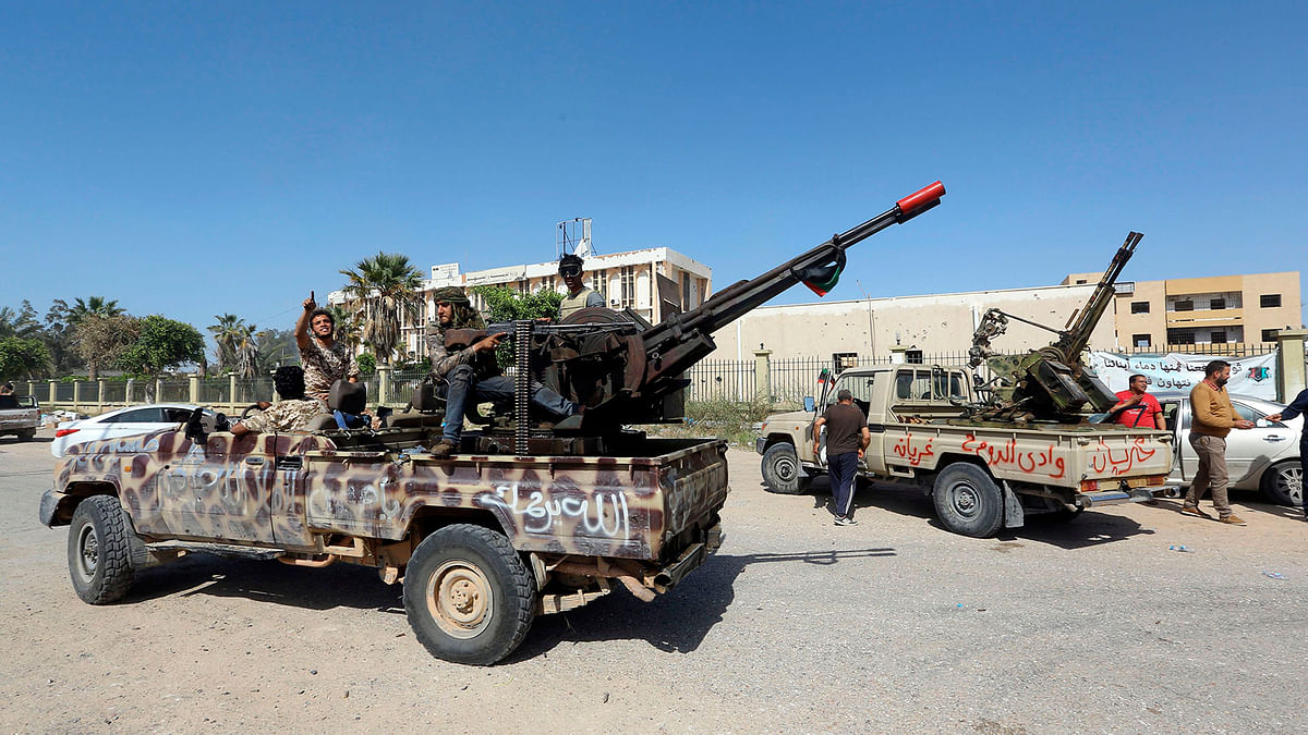 Forces loyal to Libya`s Government of National Accord (GNA) gesture on 18 April 2019, after taking control of the area of al-Aziziyah, located some 40 kilometres south of the Libyan capital Tripoli, following fierce clashes with forces loyal to strongman Khalifa Haftar. Photo: AFP
