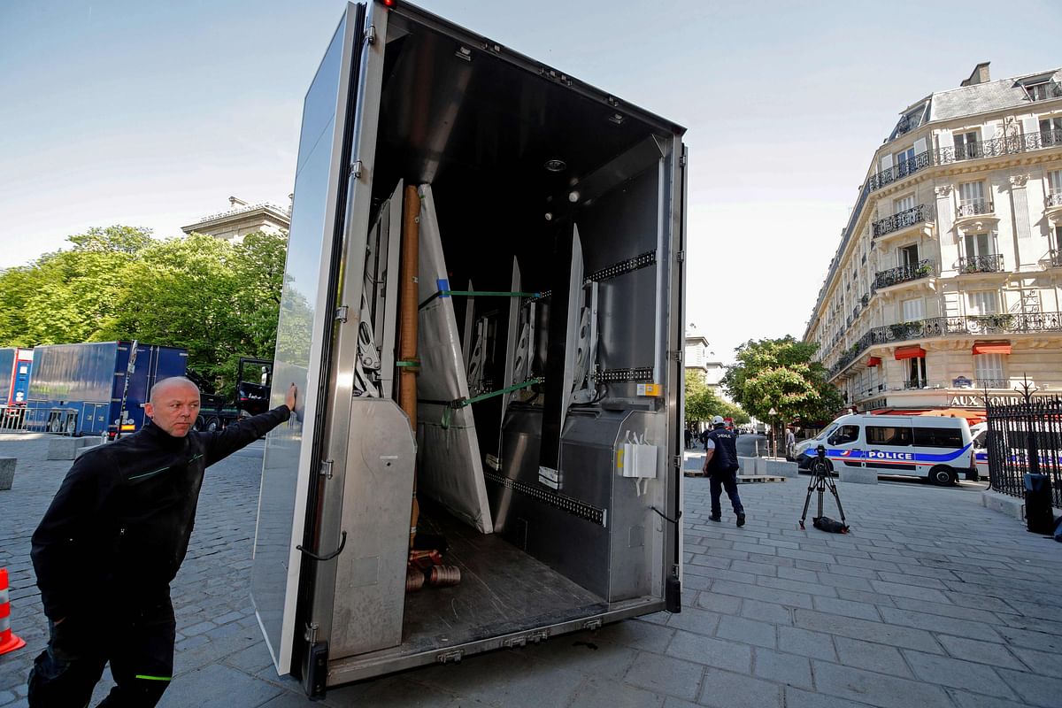 An employee stands near a truck on 19 April, 2019, in Paris, after loading large artworks saved from the fire that devastated the Notre-Dame de Paris Cathedral. Photo: AFP