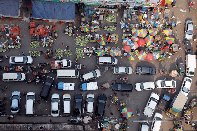 Large part of the road inside Karwan Bazar is taken over by vegetable and fruit wholesalers and by parking lots. Photo: Dipu Malakar