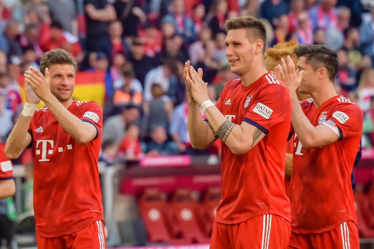 Bayern Munich players celebrate after their German Bundesliga win over Werder Bremen in Munich on April 21, 2019. AFP