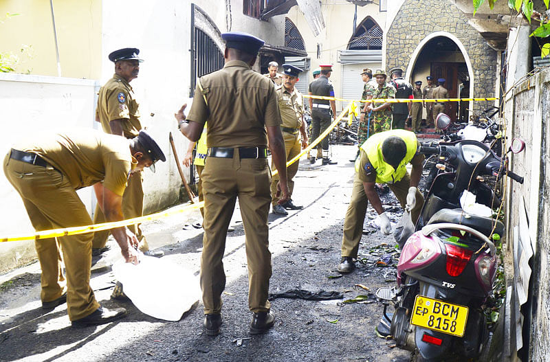 Sri Lankan security personnel and investigators look through debris outside Zion Church following an explosion in Batticaloa in eastern Sri Lanka on 21 April 2019. Photo: AFP