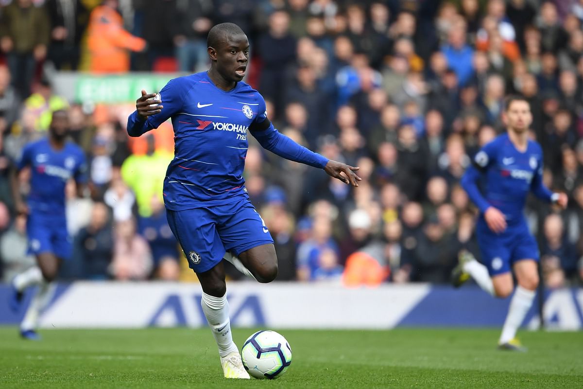 Chelsea`s French midfielder N`Golo Kante runs with the ball during the English Premier League football match between Liverpool and Chelsea at Anfield in Liverpool, north west England on April 14, 2019. AFP