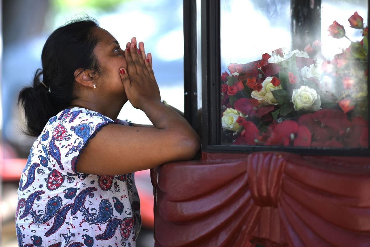 A woman prays at St. Sebastian's Church in Negombo on 22 April, 2019, a day after the building was hit as part of a series of bomb blasts targeting churches and luxury hotels in Sri Lanka. Photo: AFP