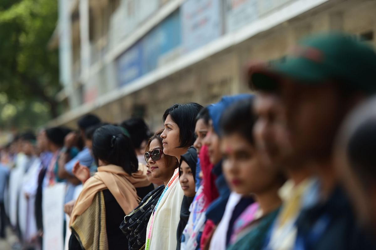 Members of the Transparency International Bangladesh group stand in a human chain during a protest in Dhaka on 21 April, 2019, following Nusrat Jahan Rafi`s murder by being set on fire after she had reported a sexual assault. Photo: AFP