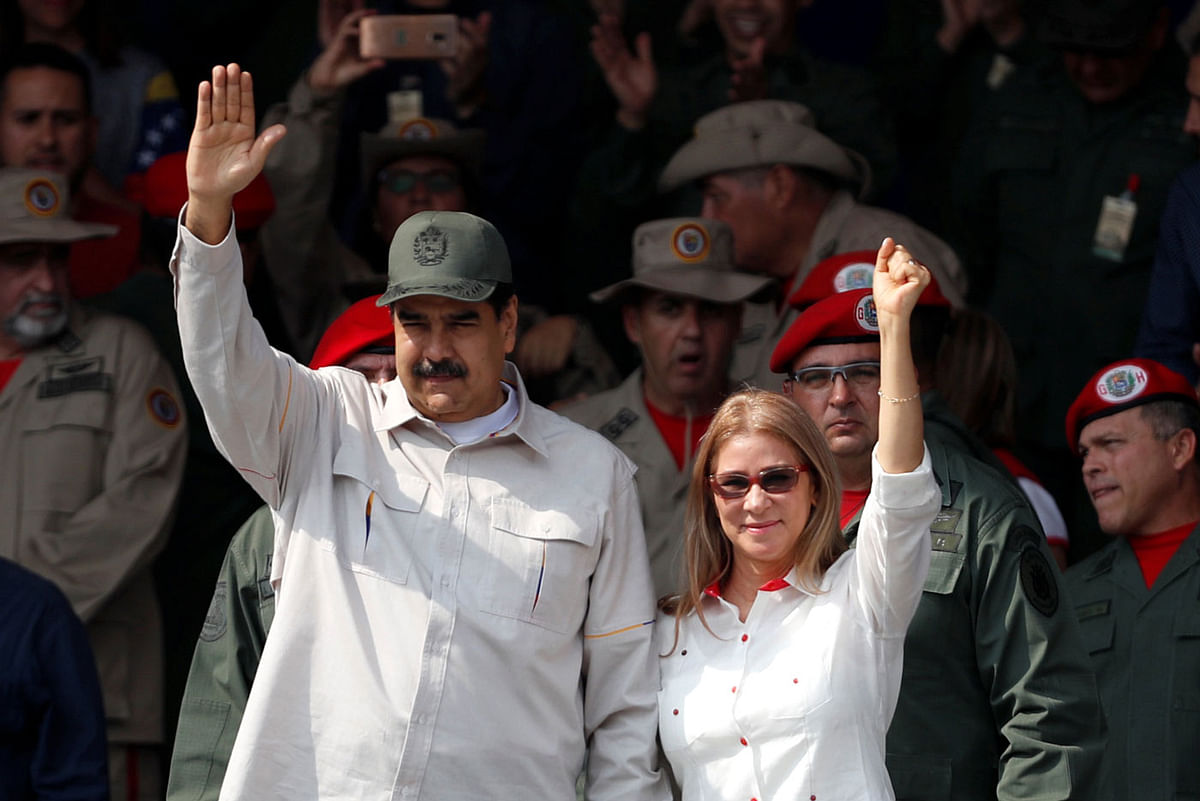 Venezuela`s president Nicolas Maduro, next to his wife Cilia Flores, waves as he takes part in a ceremony to mark the 17th anniversary of the return to power of Venezuela`s late president Hugo Chavez after a coup attempt and the National Militia Day in Caracas, Venezuela on 13 April 2019. Photo: Reuters