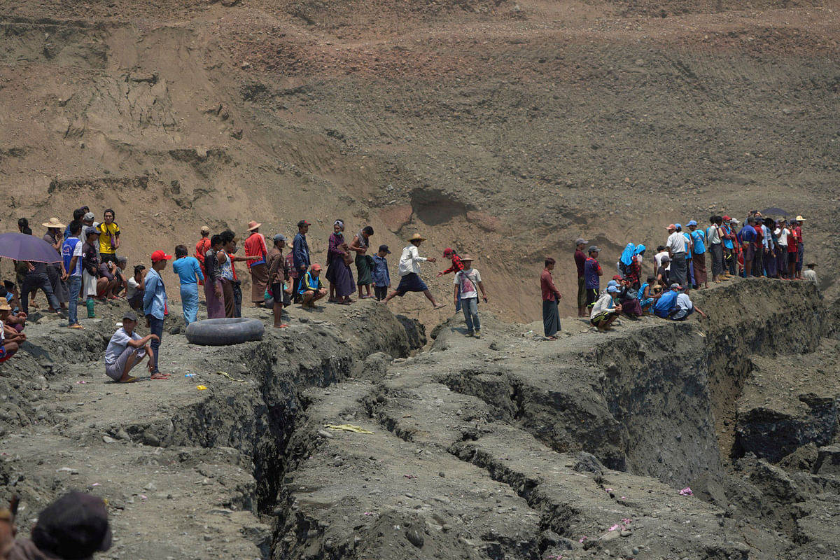 Local people look on in a jade mine where the mud dam collapsed in Hpakant, Kachin state, Myanmar on 23 April 2019. Photo: Reuters