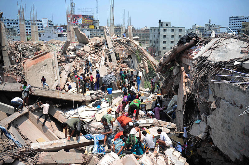 In this AFP file photo taken on 24 April 2013 Bangladeshi civilian volunteers assist in rescue operations after an eight-storey building collapsed in Savar, on the outskirts of Dhaka. Photo: AFP