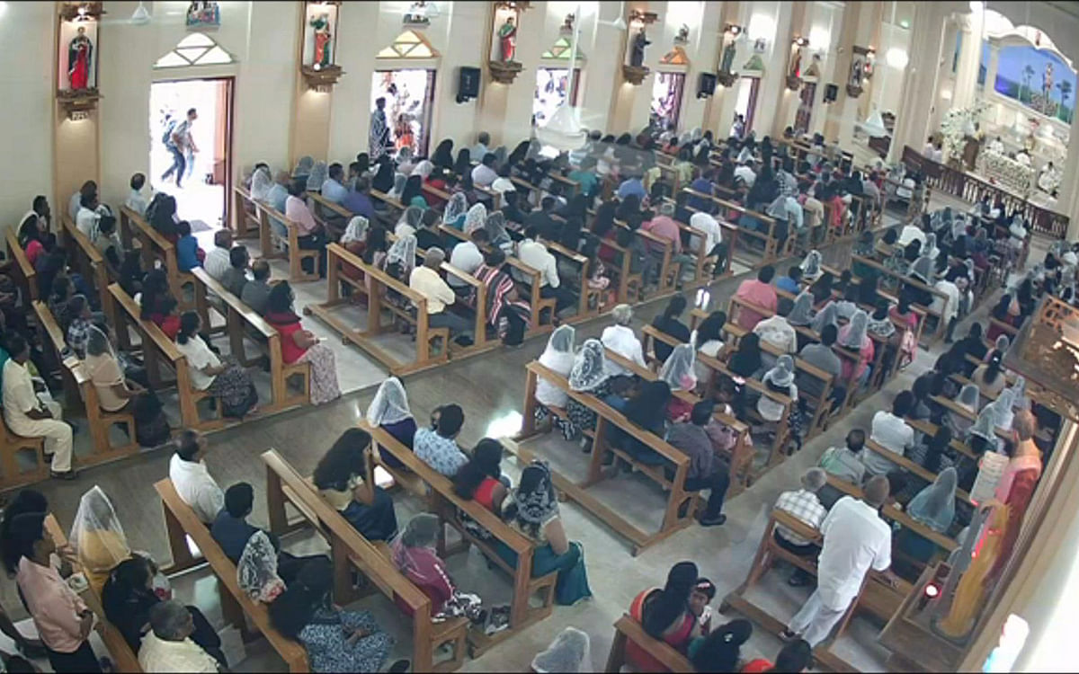 This still image taken from Sri Lankan closed-circuit TV on 21 April 2019, a suspected bomber (L framed by door)) with backpack before he enters St. Sebastian’s Church in Negombo, Sri Lanka. The Islamic State group on 23 April 2019, claimed responsibility for the devastating series of suicide attacks against churches and hotels in Sri Lanka that killed more than 320 people. Photo: AFP