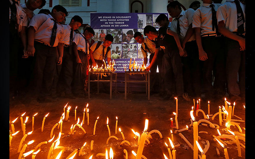 Students light candles during a vigil at a prayer meeting to show solidarity with the victims of Sri Lanka’s serial bomb blasts, outside a church in Kolkata. Photo: Reuters