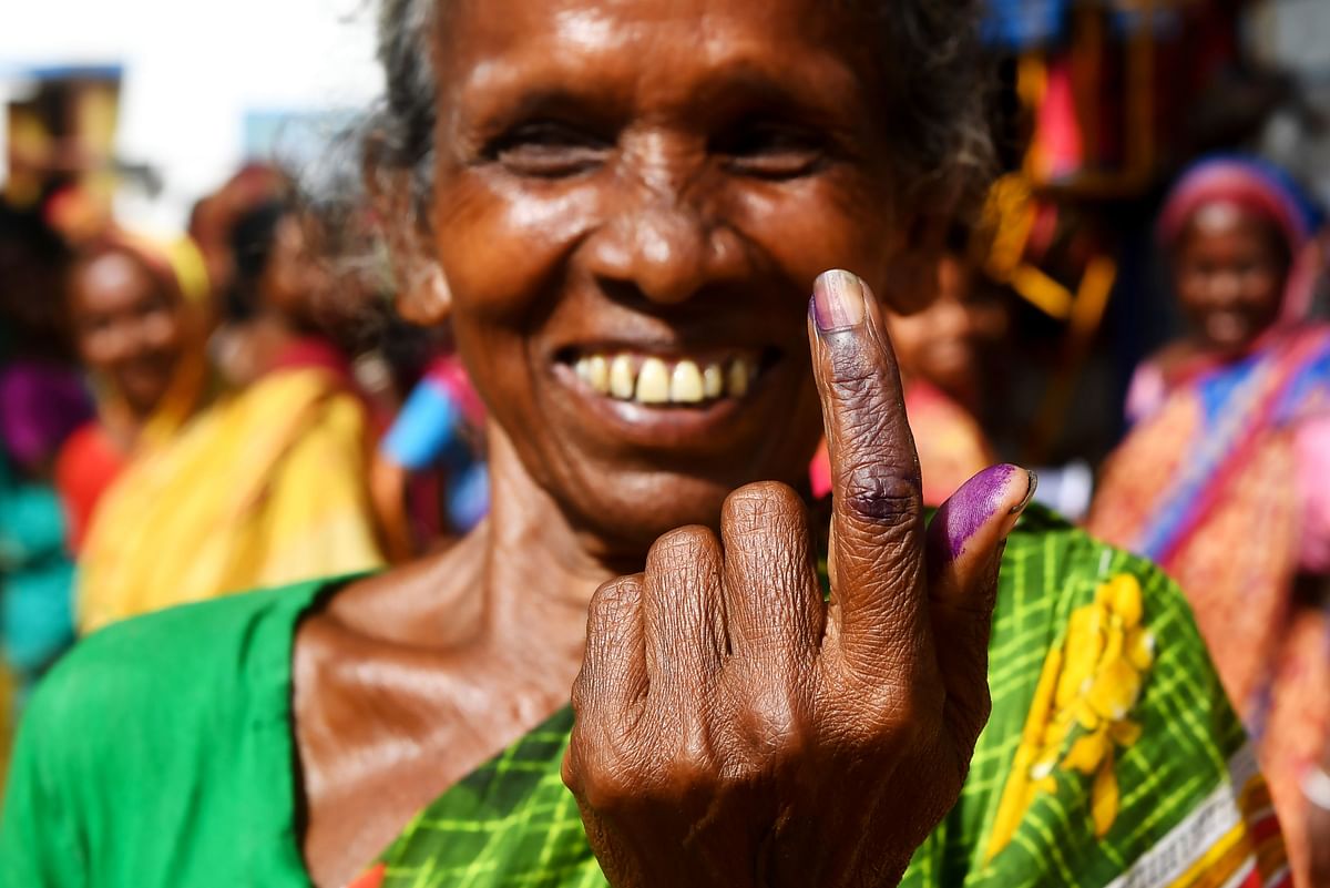 An Indian tribal voter poses for photographs showing her inked finger after casting her vote at a polling station in Illambazar area of the eastern Indian state of West Bengal around 190 km north west of Kolkata on 29 April 2019. Voting began for the fourth phase of India`s general parliamentary elections as Indians exercise their franchise in the country`s marathon election which started on 11 April and runs through to 19 May with the results to be declared on 23 May . Photo: AFP