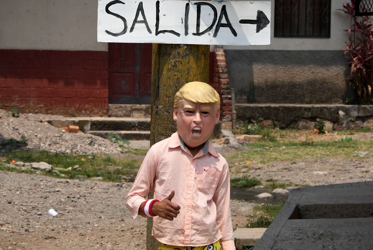 5A boy wearing a mask of US President Donald Trump poses for a picture in Cantarranas, 20 km northeast of Tegucigalpa, on 28 April 2019, during a street art event in which 55 artists from seven countries took part. Photo: AFP